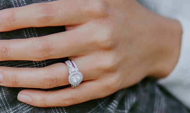 Close up of woman wearing diamond ring