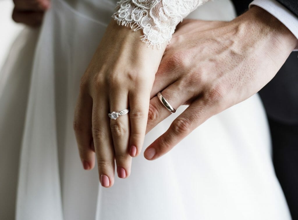Bride and Groom Showing Their Engagement Wedding Rings on Hands
